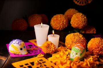 Sugar skull with Candles, Cempasuchil flowers or Marigold and Papel Picado. Decoration traditionally used in offering altars for the celebration of the day of the dead in Mexico.