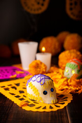 Sugar skull with Candles, Cempasuchil flowers or Marigold and Papel Picado. Decoration traditionally used in offering altars for the celebration of the day of the dead in Mexico.