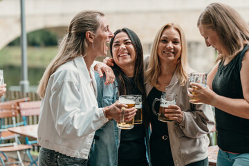 Happy women enjoy drinks and laughter at a summer party in Bavaria Germany with friends beer and festive celebration mood