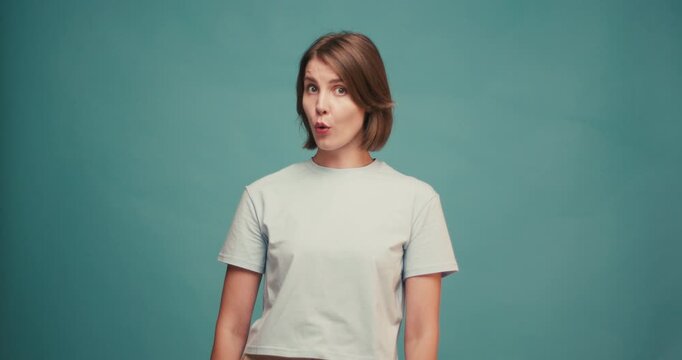 Young Hispanic woman comically wipes sweat showing that she is tired and frustrated