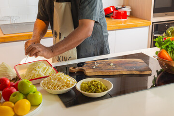 Man Preparing Fresh Cabbage and Bean Sprouts on Kitchen Counter