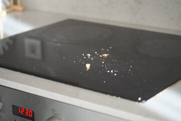 Dust and crumbs on a kitchen countertop surface