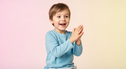 Joyful child claps hands with big smile, pure happiness concept