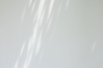 close up on white plain wall background texture with shadow of window from sunlight for ads and advertisement product such as cosmetic or content or goods design display concept