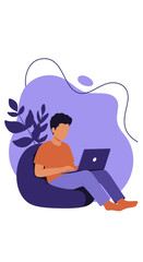 Casual young man focused on his laptop, working from home or engaging in online learning on a comfortable bean bag chair. Modern remote lifestyle.