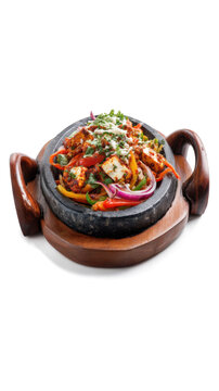 Paneer sizzler is an indian version with cottage cheese salad served sizzling on a hot stone dish isolated on a white background