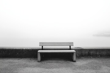 Empty gray bench on a foggy waterfront