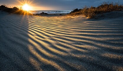 Golden sunset on a beach, wind-sculpted sand patterns