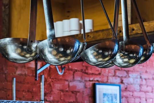 Soup ladles hanging in a restaurant kitchen
