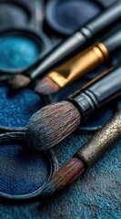 Close-up of blue eyeshadow palettes and makeup brushes