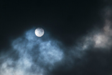 Dramatic dark clouds almost cover the sun during the day. Climate and weather concept. For graphic design, 3D rendering and banners