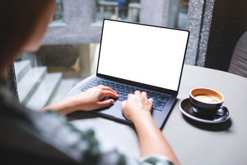Mockup image of a woman working and typing on laptop computer with blank white desktop screen in cafe