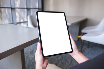 Mockup image of a woman holding digital tablet with blank white desktop screen