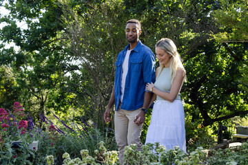 Couple walking in garden, enjoying nature and spending quality time together