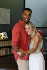 Dancing together, happy couple sharing joyful moment at home
