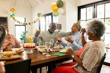 Celebrating birthday with cake, family laughing and enjoying decorations together