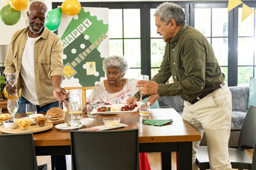 Family celebrating retirement with food and drinks, sharing joyful moments together