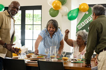 Celebrating at home, African American family sharing festive meal with laughter