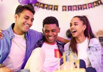 Celebrating birthday, friends laughing and enjoying party with colorful decorations