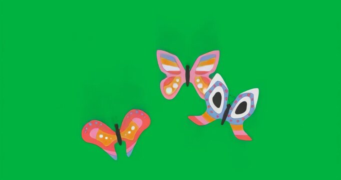 Blue-gray particles swirling initiating butterfly trio opening wings emitting teal glow to flutter