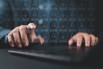 Customer list and information management CMS. Accessing client data collection system. A person typing on a laptop computer keyboard at a desk in an office.