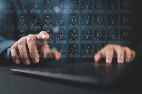 Customer list and information management CMS. Accessing client data collection system. A person typing on a laptop computer keyboard at a desk in an office.