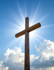 Wooden cross against blue sky with radiating sunbeams and puffy clouds, symbolizing faith and hope in a serene outdoor setting