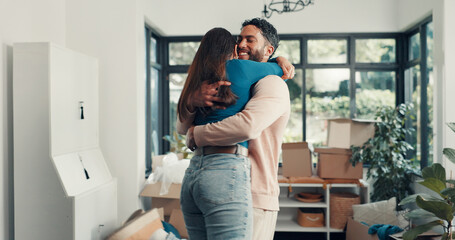 Happy couple, hug and relocation at new home with boxes, excited and fresh start with property investment. People, man and woman with embrace, care and love with moving, celebration and real estate