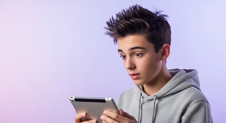 A young boy with spiky hair looks surprised while holding a tablet computer in his hands against a light purple background.