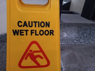 A yellow board is used to inform that the area is in the process of being cleaned