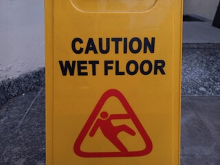 A yellow board is used to inform that the area is in the process of being cleaned