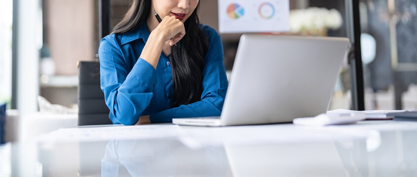 Beautiful Business Woman working by using laptop computer Hands typing on keyboard. Professional investor working new start up project. business planning in office. Technology business