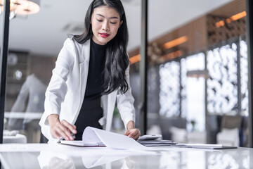 Beautiful confident asian business woman Auditor or internal revenue service staff, Business women checking annual financial statements of company. Audit Concept.