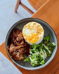 Teriyaki beef rice, fried egg, and vegetable salad