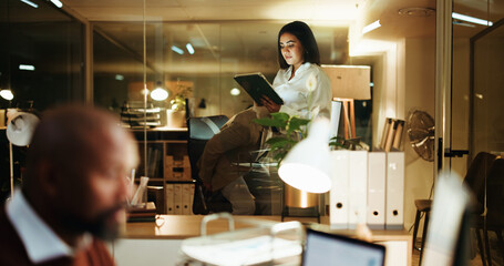 Business woman, tablet and night in office for reading, financial portfolio update or trader info...