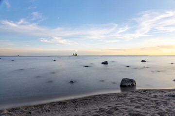 A tranquil sunset over Tiny Beach, Ontario, with serene waters reflecting the vibrant sky.