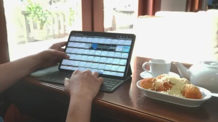 Digital lifestyle, a man using tablet with sweet dessert and tea. Enjoying leisure time indoors. - Powered by Adobe