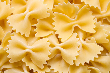 Close-up of dry pasta bows. Raw pasta bows