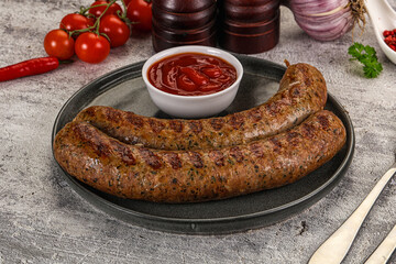 Grilled beef sausages with sauce