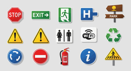 Flat lay of various colorful informational and warning signs against a neutral gray background, showcasing diverse symbols for safety, directions, and facilities.