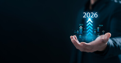 2026 Business growth concept with businessman hand holding digital arrow graphics and 2026 target. Perfect for success, strategy, planning, future vision, progress, and innovation.