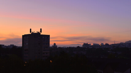 Twilight in the neighbourhood. Aerials on top of buildings.