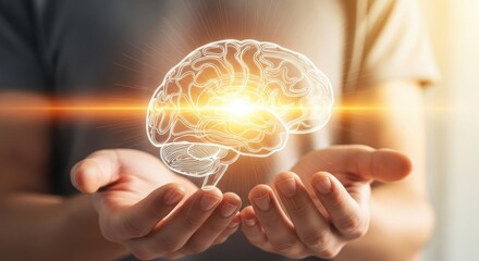 Glowing outline of a human brain with bright light emanating from its center held between two cupped hands