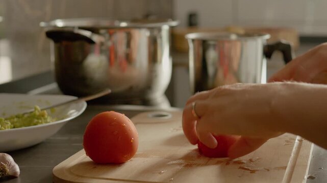 Dicing tomatoes for a delicious guacamole. Perfect for your next gathering or snack.