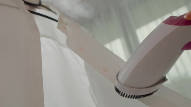 Steam is applied to a wrinkled shirt, effectively removing creases and ensuring a crisp appearance. Experience the benefits of using a handheld clothes steamer.