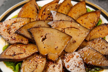 Spicy Seasoned Pork Liver Slices with Hot Pepper Sauce and Fresh Greens - Traditional Mouthwatering Dish