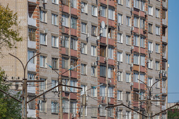 The facade of a multi-storey brick apartment building