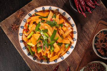Spicy Bamboo Shoots and Asparagus Stir Fry with Asian Spices on Rustic Wooden Table