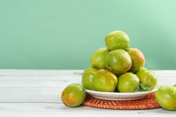 Fresh Green Xinjiang Pears on White Plate - Organic Fruit Market Display
