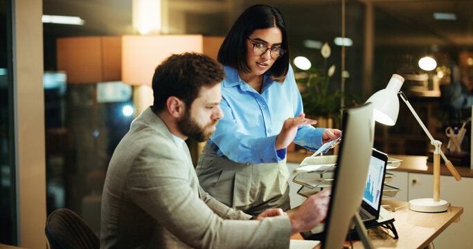 Business, night and people with charts, laptop and teamwork with conversation, profit growth and audit. Evening, man and woman in office, computer and graphs for stock market investment and increase